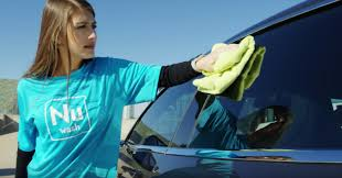 NuWash logo and a car getting detailed