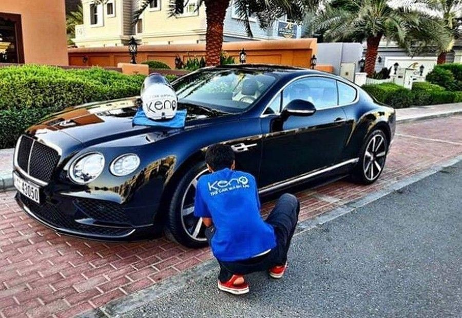 Car wash app interface on a smartphone with a clean car in the background